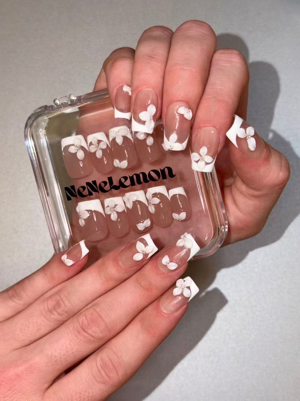 White jasmine press ons medium squoval worn on hands daily look