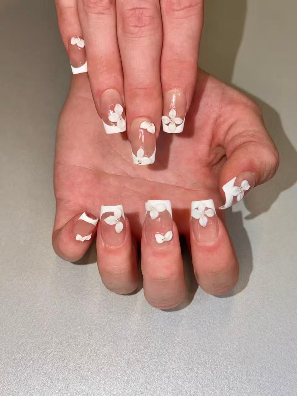 White jasmine press ons medium squoval worn on hands daily look