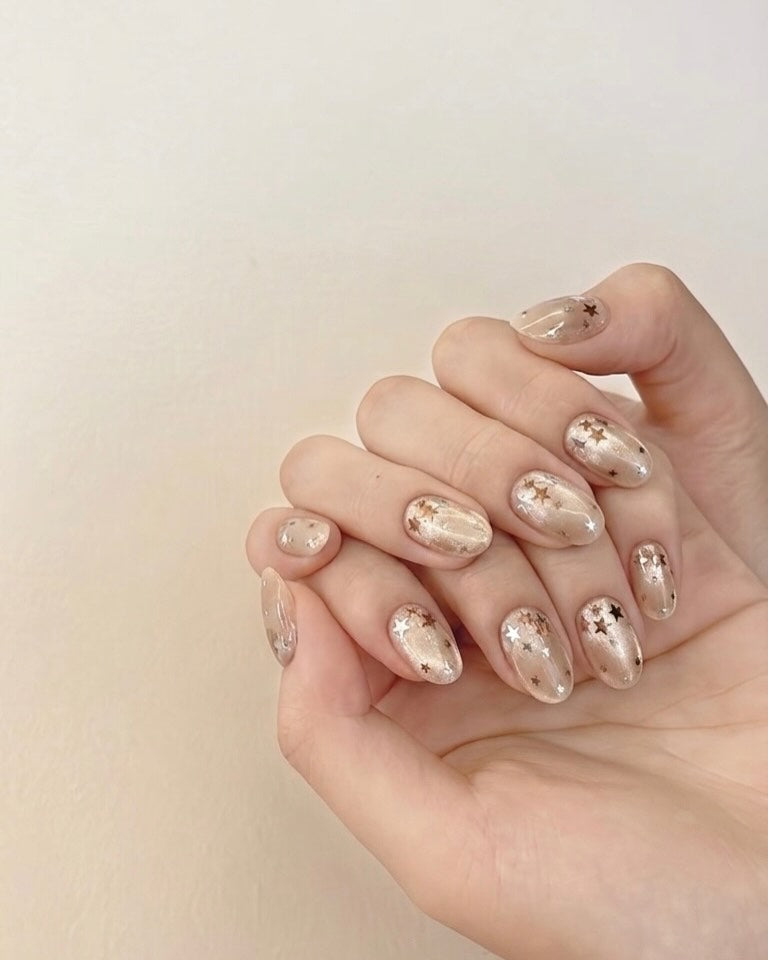 Champagne gold cat-eye press ons short oval worn on hands, everyday look